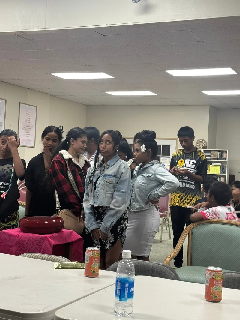 Young church members fellowshipping together inside the church.
