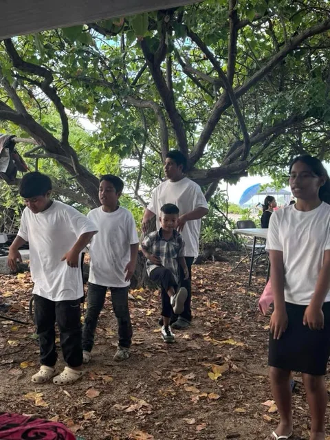 Group of people under a tree.